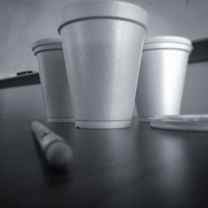 three cups of coffee sitting on a desk